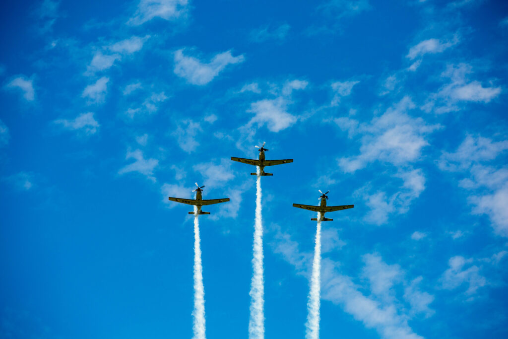 3 small planes flying overhead