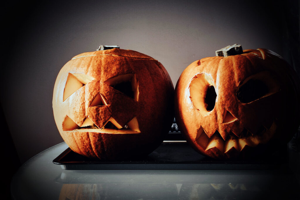 Two carved pumpkins on a table